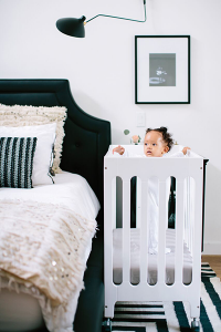 Collapsible cribs aren’t just for travel—they’re perfect for a small space nursery!