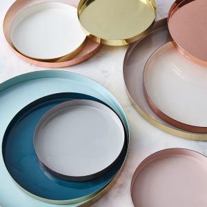 Circular brass serving trays gracefully walk the line of chic and showstopping, giving dinner guests just a hint of metallic sheen for a pop.
