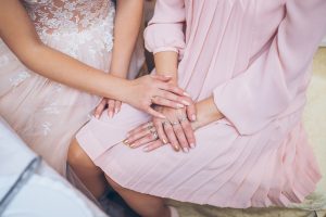 bride and mother holding hands | tips for family wedding drama