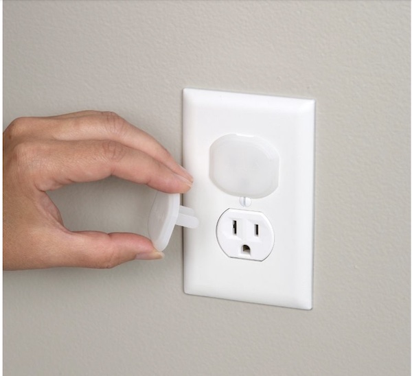 Hand placing an outlet cover on an outlet