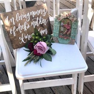 Honoring lost loved ones at wedding with a reserved seat sign