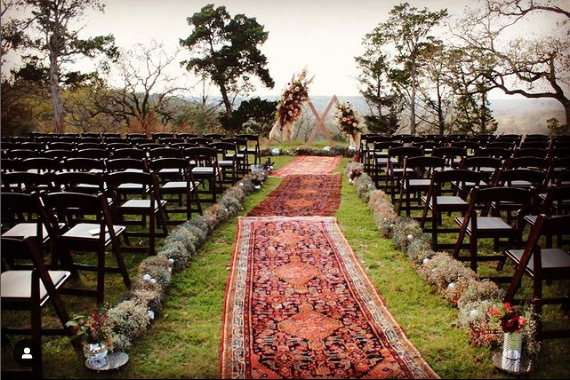 Line your wedding aisle with vintage rugs