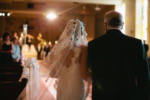 Father of the bride walking daughter down the aisle