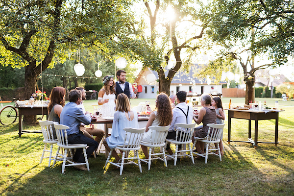 Bride and groom giving speech at backyard wedding