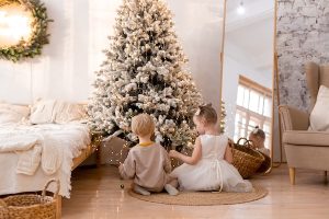 kids by Christmas tree