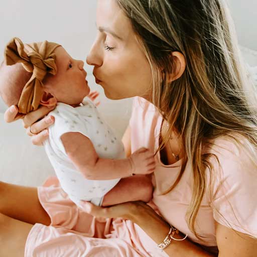 mom kissing baby